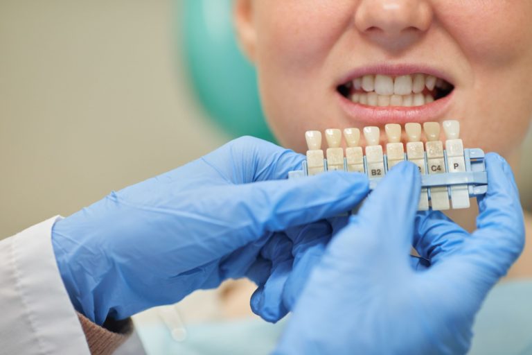 doctor showing patient tooth implant